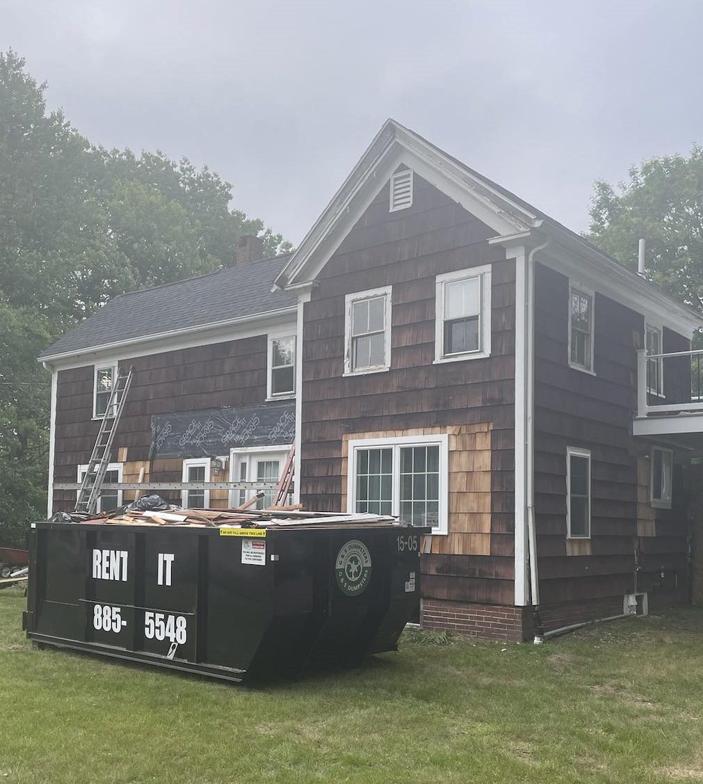 Dumpster filled with siding